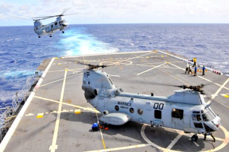 US Navy 110226-N-7042V-009 CH-46E Sea Knight helicopters assigned to the Evil Eyes of Marine Medium Helicopter Squadron (HMM) 163 land aboard the a