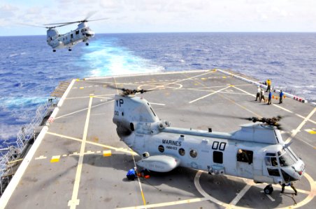 US Navy 110226-N-7042V-009 CH-46E Sea Knight helicopters assigned to the Evil Eyes of Marine Medium Helicopter Squadron (HMM) 163 land aboard the a photo