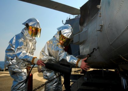 US Navy 110219-N-9793B-029 Sailors assigned to the guided-missile cruiser USS Anzio (CG 68) simulate a helicopter crash on the flight deck