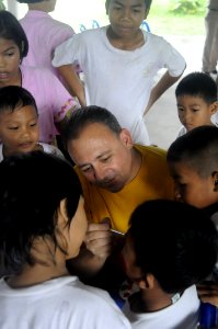 US Navy 110223-N-4920H-078 Lt. Gregory Flores paints the face of a student during a community service event at Bannok School
