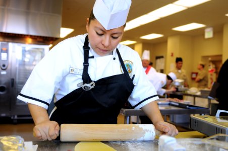 US Navy 110301-N-1401J-017 ulinary Specialist 2nd Class Sophia Palafoxl rolls dough with a rolling pin during the 2011 Commander, Navy Region South photo