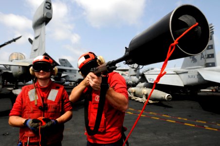 US Navy 110225-N-8040H-236 Sailors prepare to shoot a phone and distance line during a replenishment at sea photo