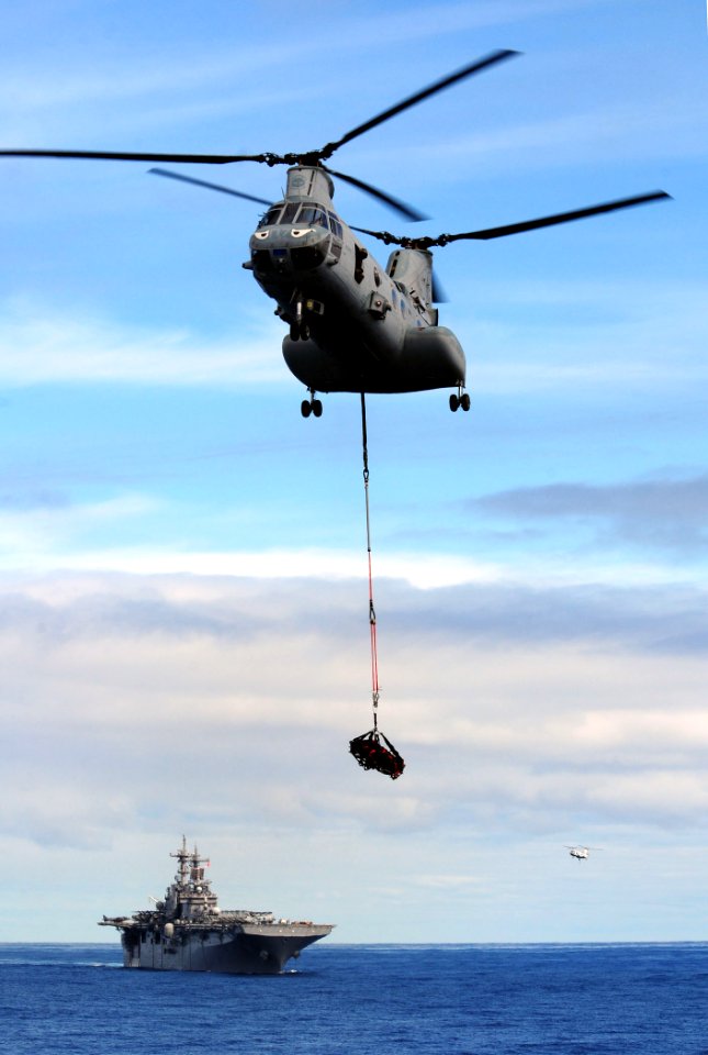US Navy 110224-N-RC734-120 A CH-46E Sea Knight helicopter transfers ammunition to USS Comstock (LSD 45) from USS Boxer (LHD 4)