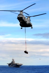 US Navy 110224-N-RC734-120 A CH-46E Sea Knight helicopter transfers ammunition to USS Comstock (LSD 45) from USS Boxer (LHD 4)