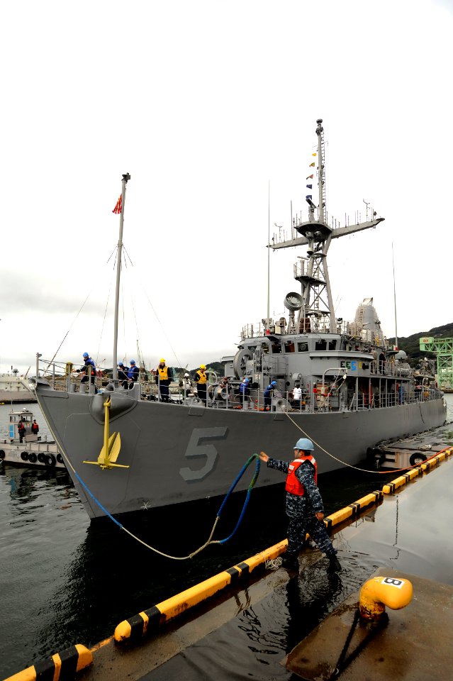 US Navy 110228-N-OX597-061 Boatswain's Mate 2nd Class Edwin Ramirez unmoors USS Guardian (MCM 5)