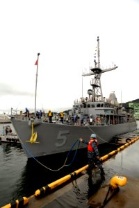 US Navy 110228-N-OX597-061 Boatswain's Mate 2nd Class Edwin Ramirez unmoors USS Guardian (MCM 5)