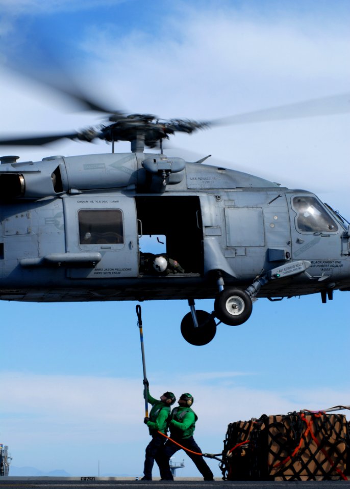 US Navy 110301-N-SB672-331 Sailors attach a cargo pennant to an HH-60H Sea Hawk helicopter assigned to the Black Knights of Helicopter Anti-Submari