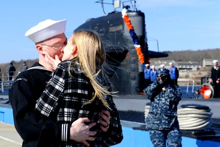 US Navy 110302-N-8467N-003 Electronics Technician 3rd Class Christopher Shepardpearson receives the traditional first kiss from his wife after the