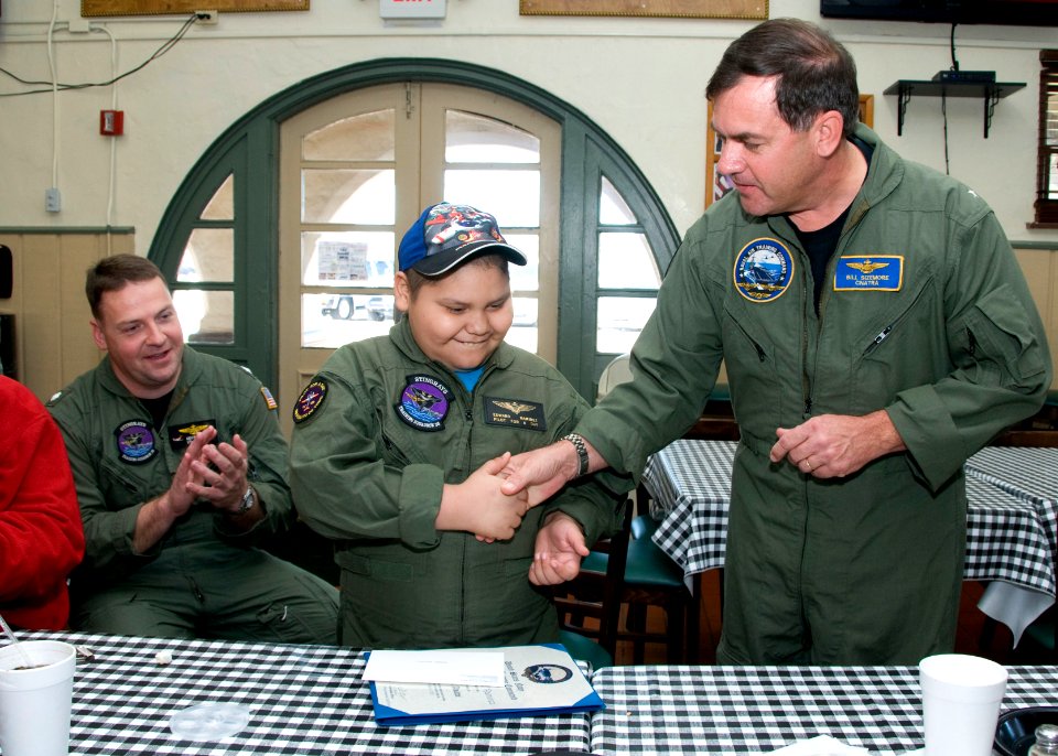 US Navy 110302-N-LY958-049 Rear Adm. Bill Sizemore congratulates a boy acting as pilot for the day as part of the Pilot For a Day program at Naval