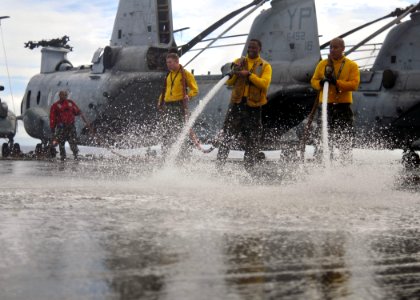 US Navy 110228-N-ZS026-105 Sailors wash the flight deck of the amphibious assault ship USS Boxer (LHD 4)