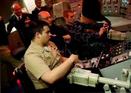 US Navy 110301-N-FG395-019 Sailors assigned to the Ohio-class ballistic-missile submarine USS Alaska (SSBN 732), operate the controls of the dive s