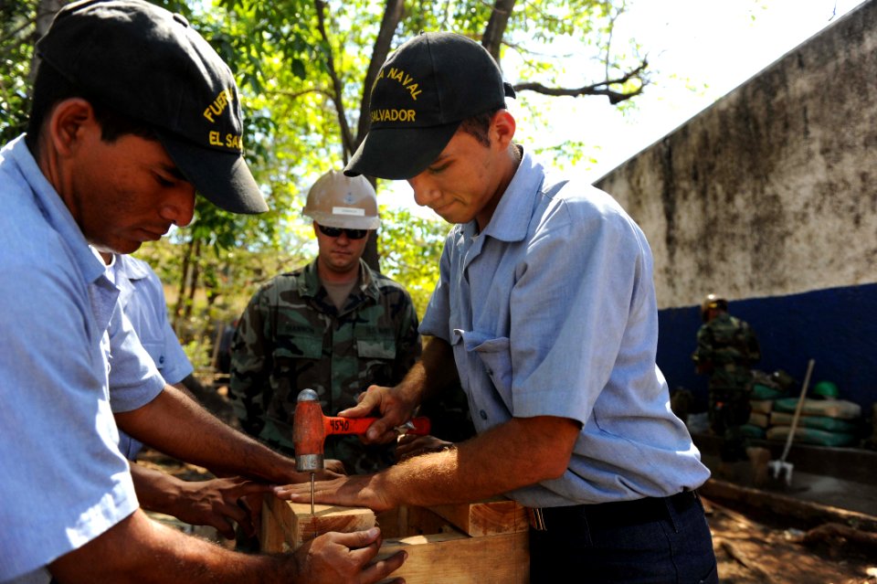 US Navy 110223-N-WX845-085 Equipment Operator 2nd Class Danny Shannon, assigned to Naval Mobile Construction Battalion (NMCB) 28, helps Salvadoran