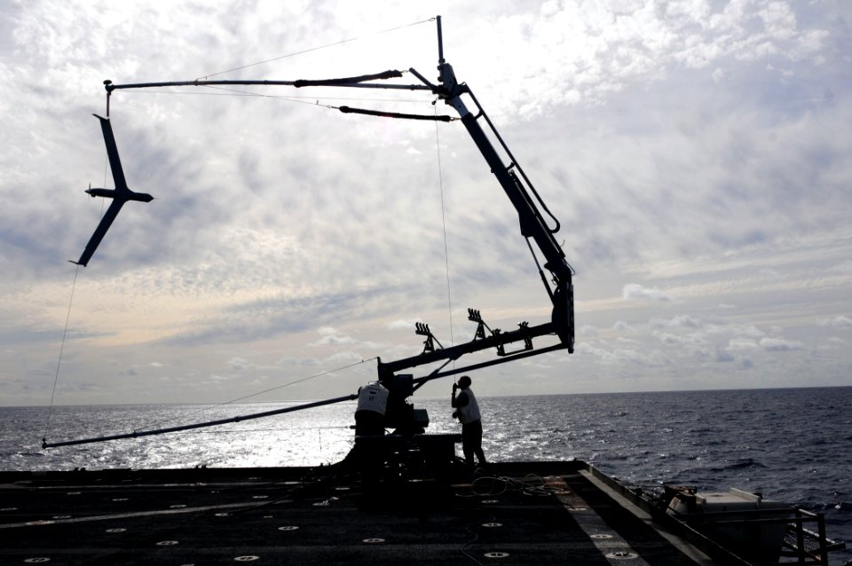 US Navy 110226-N-RC734-088 Members of the Scan Eagle team position the Skyhook arrested recovery system over the flight deck to remove a Scan Eagle