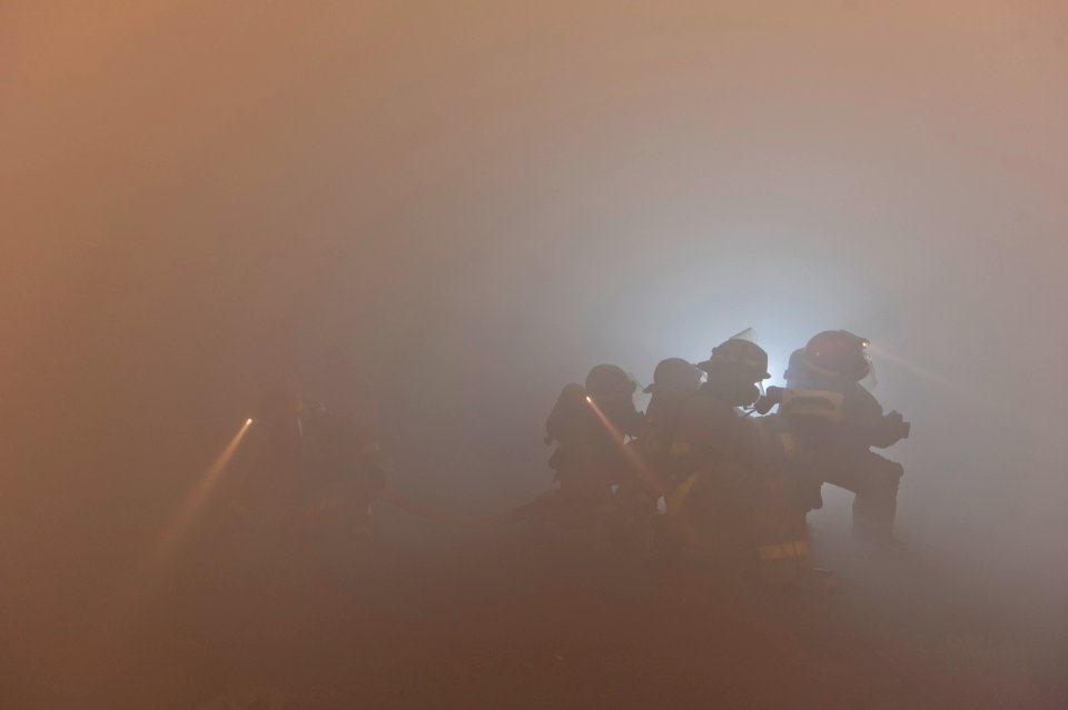 US Navy 110226-N-DR144-241 Sailors combat a simulated class bravo fire during a general quarters drill aboard USS Carl Vinson (CVN 70)