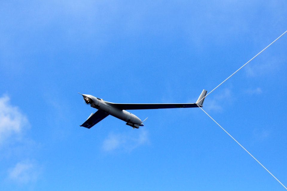 US Navy 110226-N-RC734-156 A Scan Eagle Unmanned Aerial Vehicle (UAV) makes an arrested recovery on the Skyhook recovery system aboard the amphibio