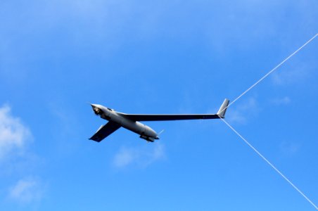 US Navy 110226-N-RC734-156 A Scan Eagle Unmanned Aerial Vehicle (UAV) makes an arrested recovery on the Skyhook recovery system aboard the amphibio
