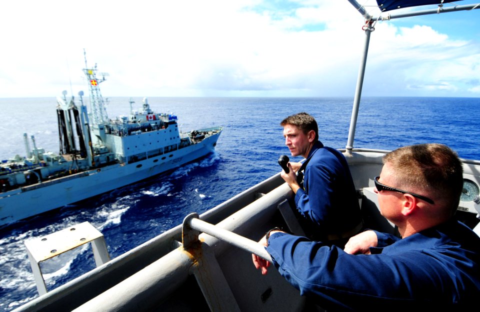 US Navy 110227-N-RC734-054 Cmdr. Lance Lesher, commanding officer of the amphibious dock landing ship USS Comstock (LSD 45) observe the Canadian na