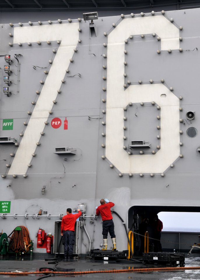 US Navy 110304-N-DM338-105 Sailors paint the island structure of the aircraft carrier USS Ronald Reagan (CVN 76). Routine maintenance, cleaning and