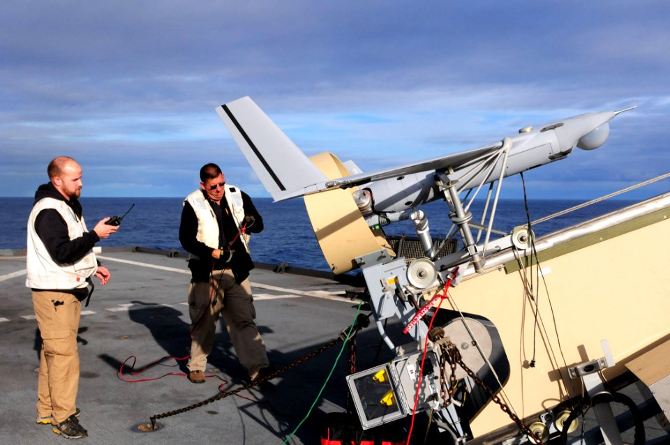 US Navy 110224-N-RC734-317 Guy Mcallister, from Insitu Group, left, and Jason Wolfram, from Boeing Inc., perform pre-flight checks on a Scan Eagle