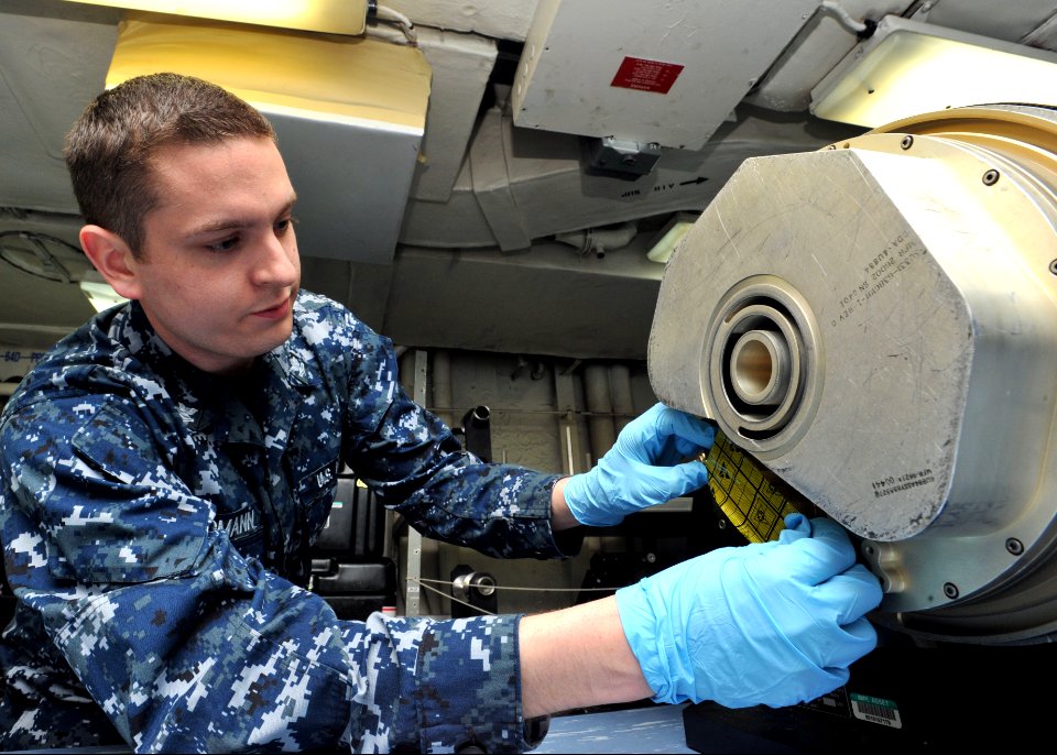US Navy 110305-N-0569K-044 Aviation Electronics Technician 2nd Class Jason J. Erdmann performs maintenance on an electro-optical sensor unit from