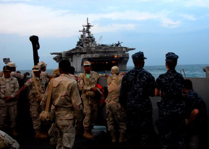 US Navy 110228-N-8607R-014 Sailors assigned to the forward-deployed amphibious assault ship USS Essex (LHD 2) and the Royal Cambodian Navy look at