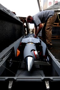 US Navy 110225-N-RC734-011 Guy Mcallister, from Insitu Group, performs maintenance on the Scan Eagle unmanned aerial vehicle (UAV) aboard the amphi