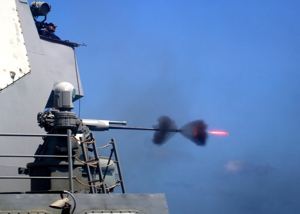 US Navy 110228-N-5838W-004 An MK-38 25mm gun system is fired during a live-fire exercise aboard the guided-missile destroyer USS Mason (DDG 87)