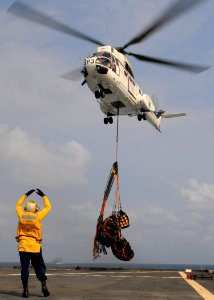 US Navy 110226-N-6692A-150 Boatswain's Mate 3rd Class Michael Bailey, assigned to the amphibious dock landing ship USS Germantown (LSD 42), signals