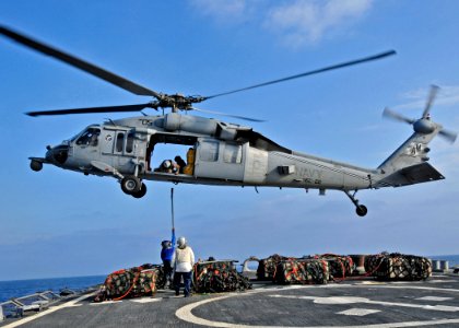 US Navy 110303-N-XO436-140 Sailors aboard USS Barry (DDG 52) attach a cargo pennant to a MH-60S Sea Hawk helicopter