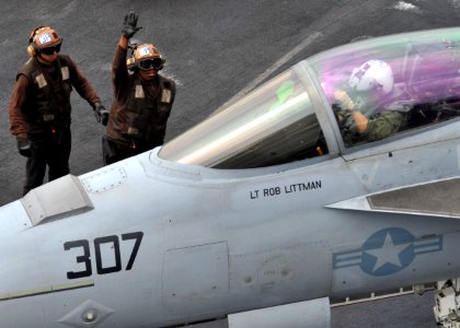 US Navy 110307-N-0569K-020 A plane captain signals to a pilot before a cycle of flight operations aboard USS Enterprise (CVN 65)
