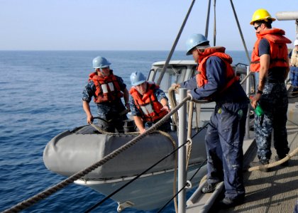 US Navy 110307-N-OY473-083 Sailors aboard USS Carter Hall (LSD 50) prepare to lower a rigid-hull inflatable boat into the water