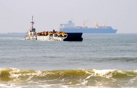 US Navy 110304-N-1786N-063 A causeway ferry makes its approach to the beach after receiving vehicles from the Military Sealift Command container ro