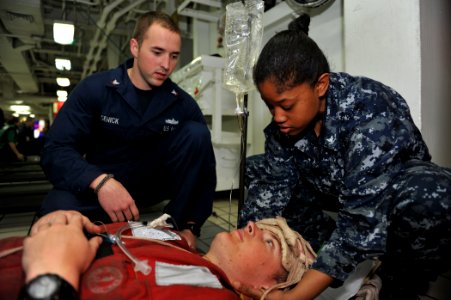 US Navy 110306-N-PM781-004 Hospital Corpsman 3rd Class Dylan Usenick and Hospital Corpsman 3rd Class Rachal Lewis provide medical treatment to a pa photo