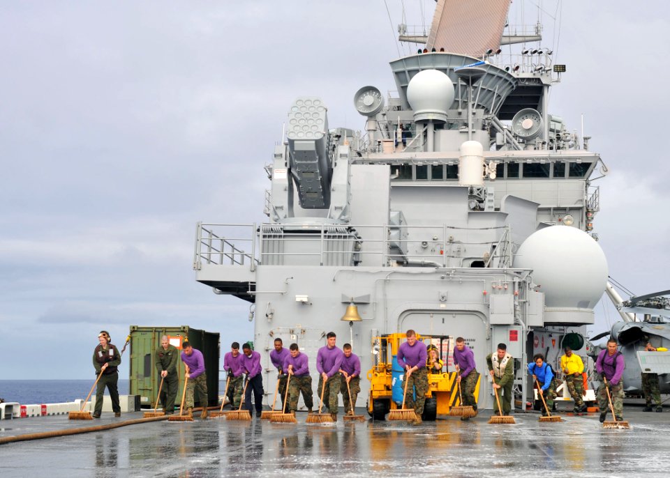 US Navy 110228-N-ZS026-203 Sailors and Marines aboard the amphibious assault ship USS Boxer (LHD 4) clean the flight deck