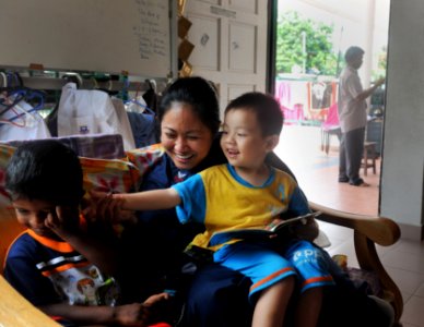 US Navy 110308-N-0864H-332 Information Systems Technician 1st Class Charmaine Bacon plays with children during a community service event at Rhuma J