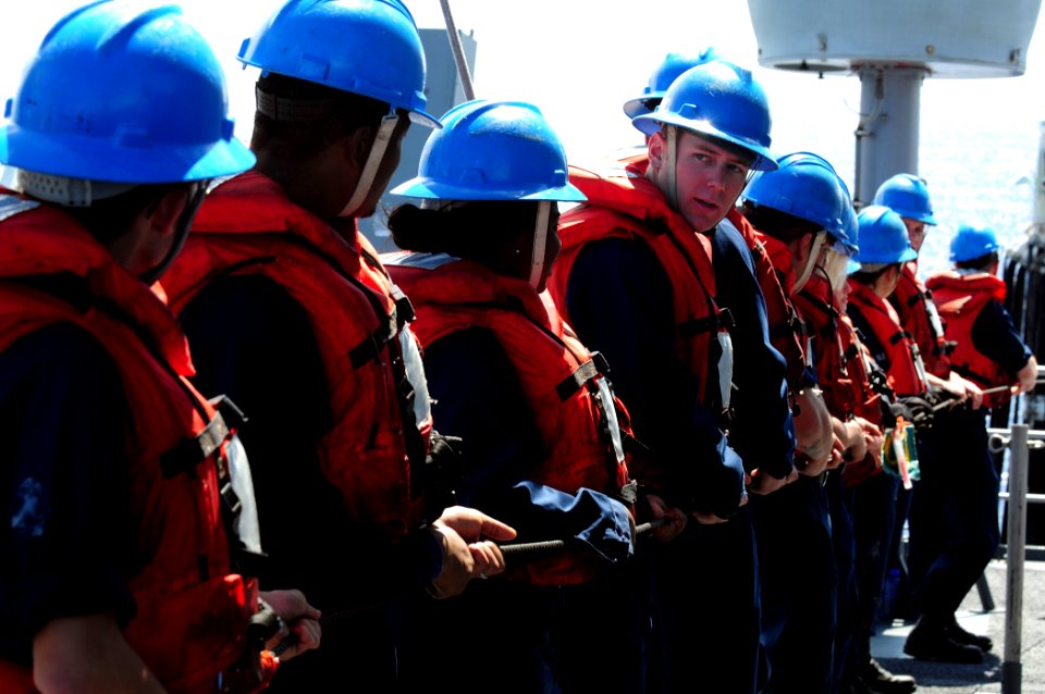 US Navy 110227-N-RC734-254 Sailors serving as line handlers man the phone and distance line aboard the amphibious dock landing ship USS Comstock (L