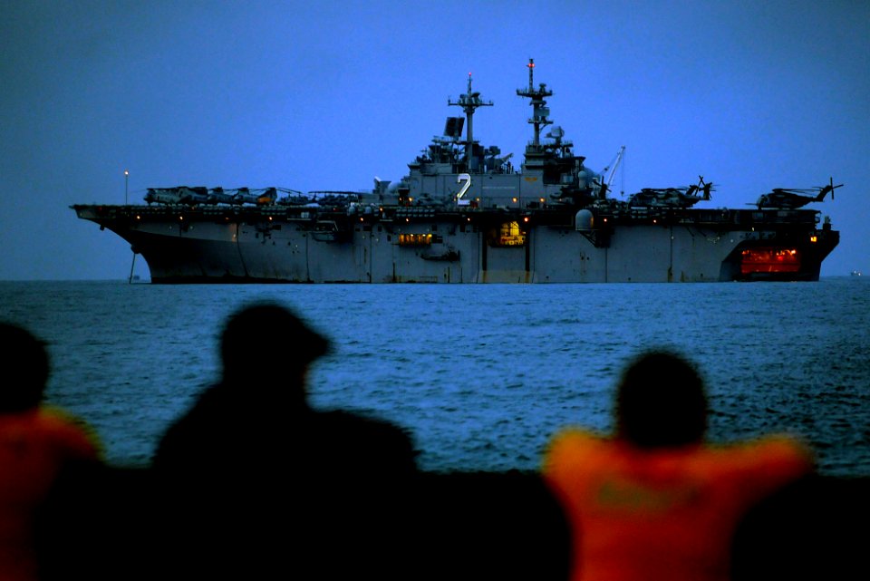 US Navy 110302-N-4743B-060 Sailors watch from a landing craft utility as they pull away from SS Essex (LHD 2) off the coast of the Kingdom of Cambo