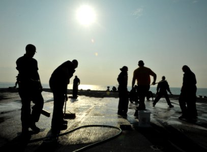 US Navy 110306-N-0864H-301 Aircrew members scrub the flight deck for debris aboard USS Blue Ridge (LCC 19)