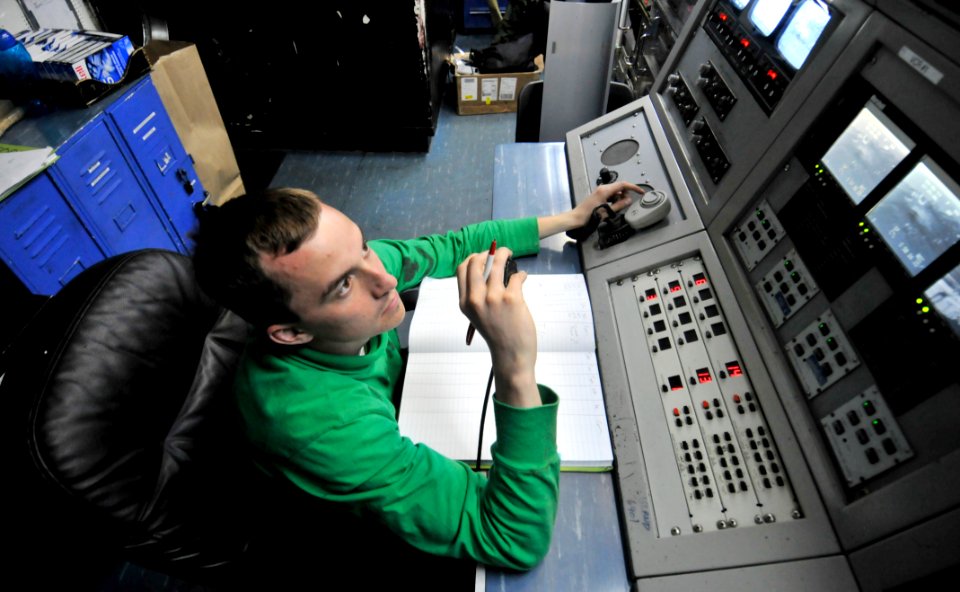 US Navy 110306-N-3852A-080 Interior Communications Specialist 3rd Class Richard Stainton operates the visual landing aid console while monitoring f