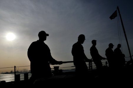 US Navy 110309-N-9818V-188 Sailors man a line during sea and anchor detail aboard the Arleigh Burke-class guided-missile destroyer USS Decatur (DDG