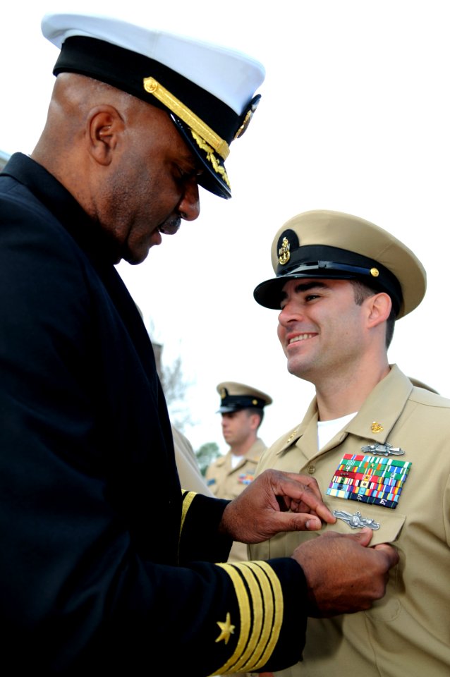US Navy 110303-N-5328N-972 Senior Chief Sonar Technician (Surface) Matt Lewis, right, receives the Navy's newly-created enlisted information domina