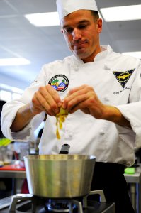 US Navy 110301-N-1401J-028 ulinary Specialist 2nd Class Brian Dunne mixes ingredients during the 2011 Commander, Navy Region Southwest Culinary Com photo