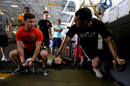 US Navy 110301-N-8040H-044 Brett Pelfrey, fit boss aboard the aircraft carrier USS Carl Vinson (CVN 70), and Airman Joel Metzger demonstrate an exe