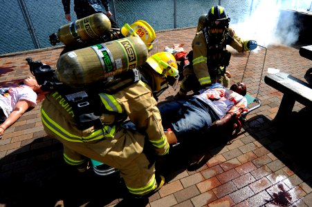 US Navy 110302-N-OX597-264 Firefighters transport Seaman Johnny Thrower, assigned to the amphibious assault ship USS Essex (LHD 2), to an ambulance