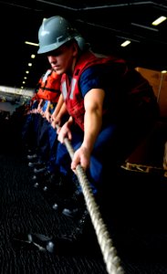 US Navy 110304-N-8040H-004 Sailors man a line during a replenishment at sea aboard USS Carl Vinson (CVN 70) photo