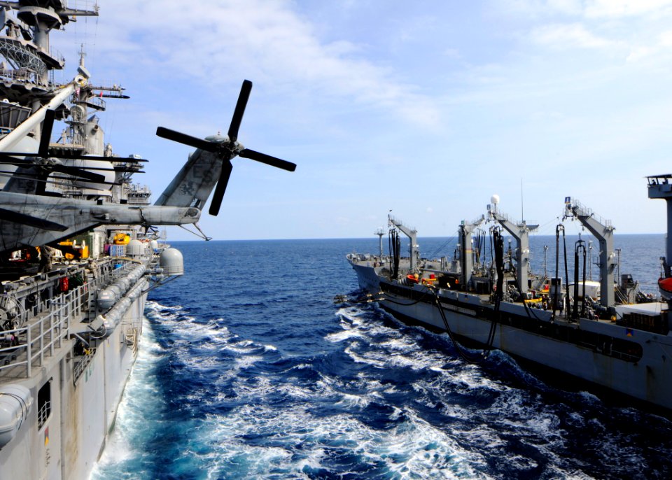 US Navy 110310-N-3154P-055 The Military Sealift Command fleet replenishment oiler USNS Kanawha (T-AO 196), right, extends fuel lines to the amphibi