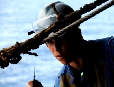 US Navy 110305-N-0864H-851 Seaman Kyle Burch cuts line aboard the U.S. 7th Fleet command ship USS Blue Ridge (LCC 19) during a replenishment at sea