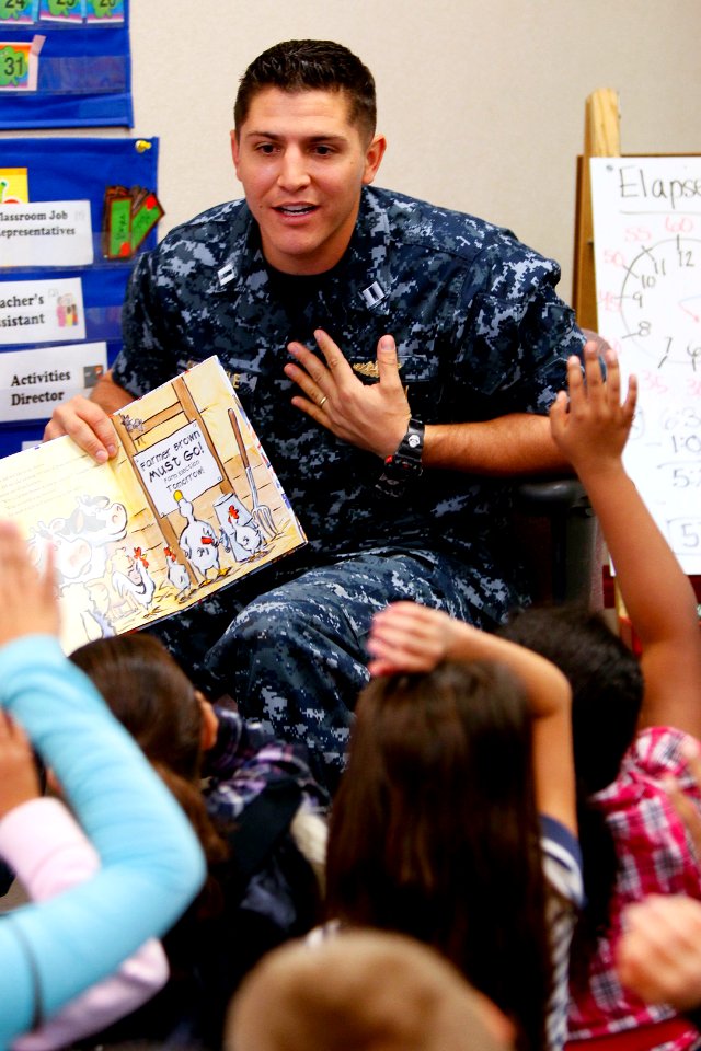 US Navy 110302-N-HW977-168 Lt. William Schindele reads Duck For President to students at Clara Barton Elementary School during an annual Read Acros