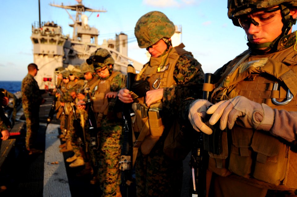 US Navy 110305-N-RC734-034 Marines load their magazines and make final preparations before a small-arms live-fire exercise aboard USS Comstock (LSD