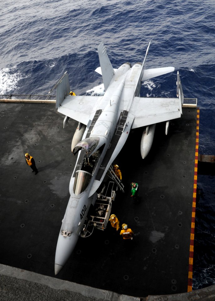 US Navy 110302-N-SG869-198 Sailors assigned to the air department of the aircraft carrier USS Ronald Reagan (CVN 76) move an F-A-18C Hornet assigne